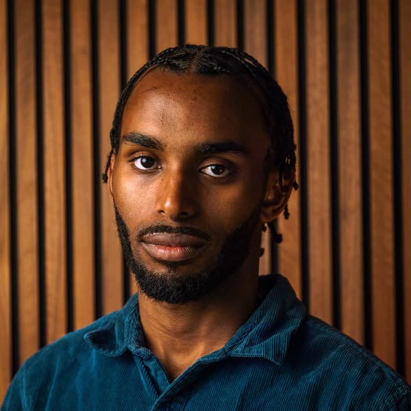 Portrait of Judah Daniels against wooden slats