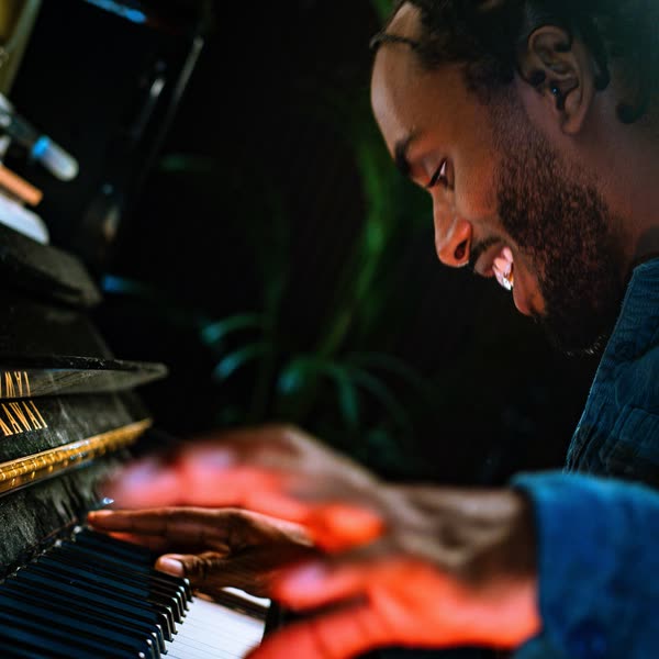Judah's hands on the keys, smiling, close up